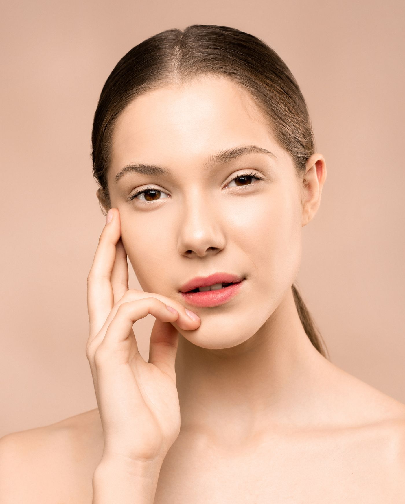 A woman with luminous, natural-looking skin in soft window light
