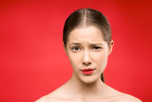 Free Woman With Red Lipstick and Red Background Stock Photo