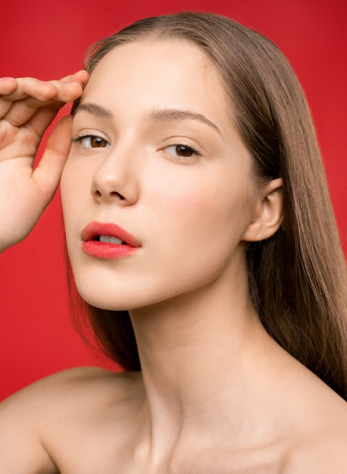 Woman With Red Lipstick and Red Background