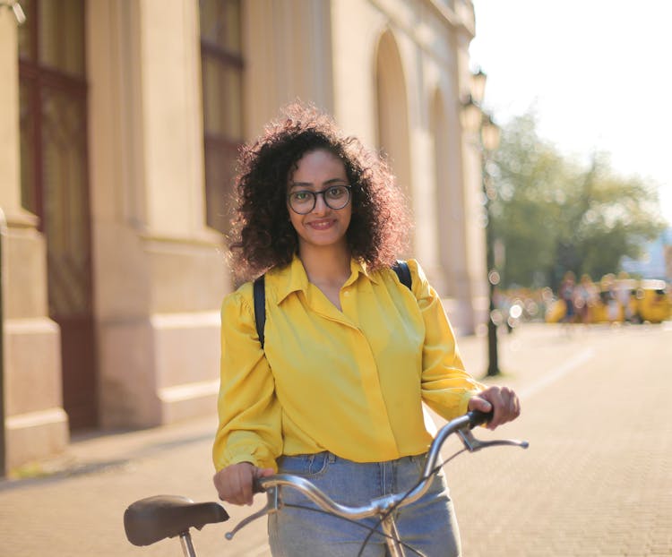 Woman Standing Beside Her Bicycle