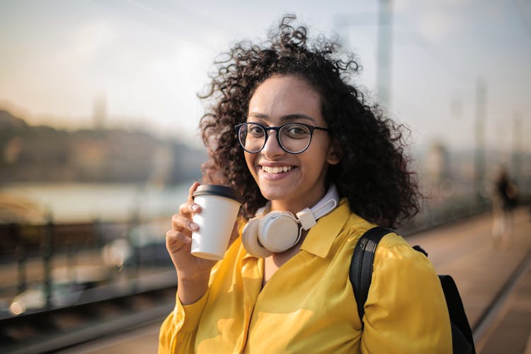 Woman With White Headset Drinking Coffee