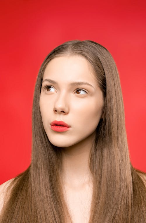 Woman in Red Lipstick and Red Background