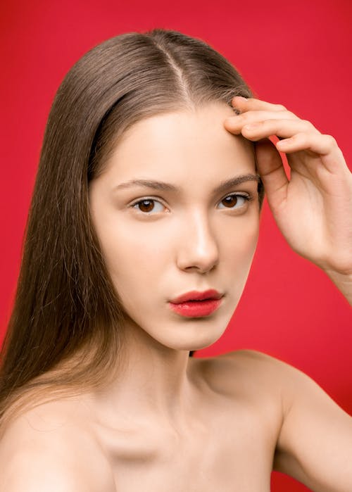 Free Woman With Red Lipstick Touching Her Head Stock Photo