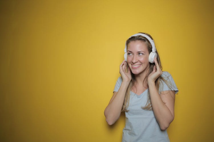 Woman Listening Music In White Headphones