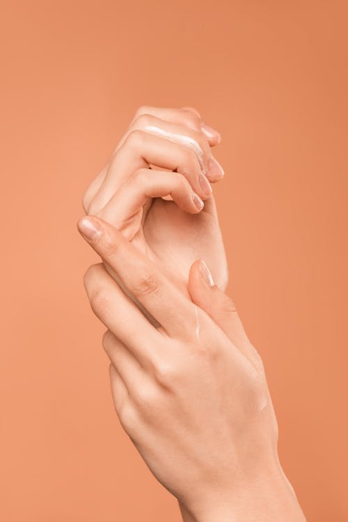 Persons Hand on Orange Background Better Skin While Working from Home