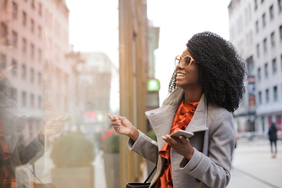Free Happy black woman laughing on street Stock Photo
