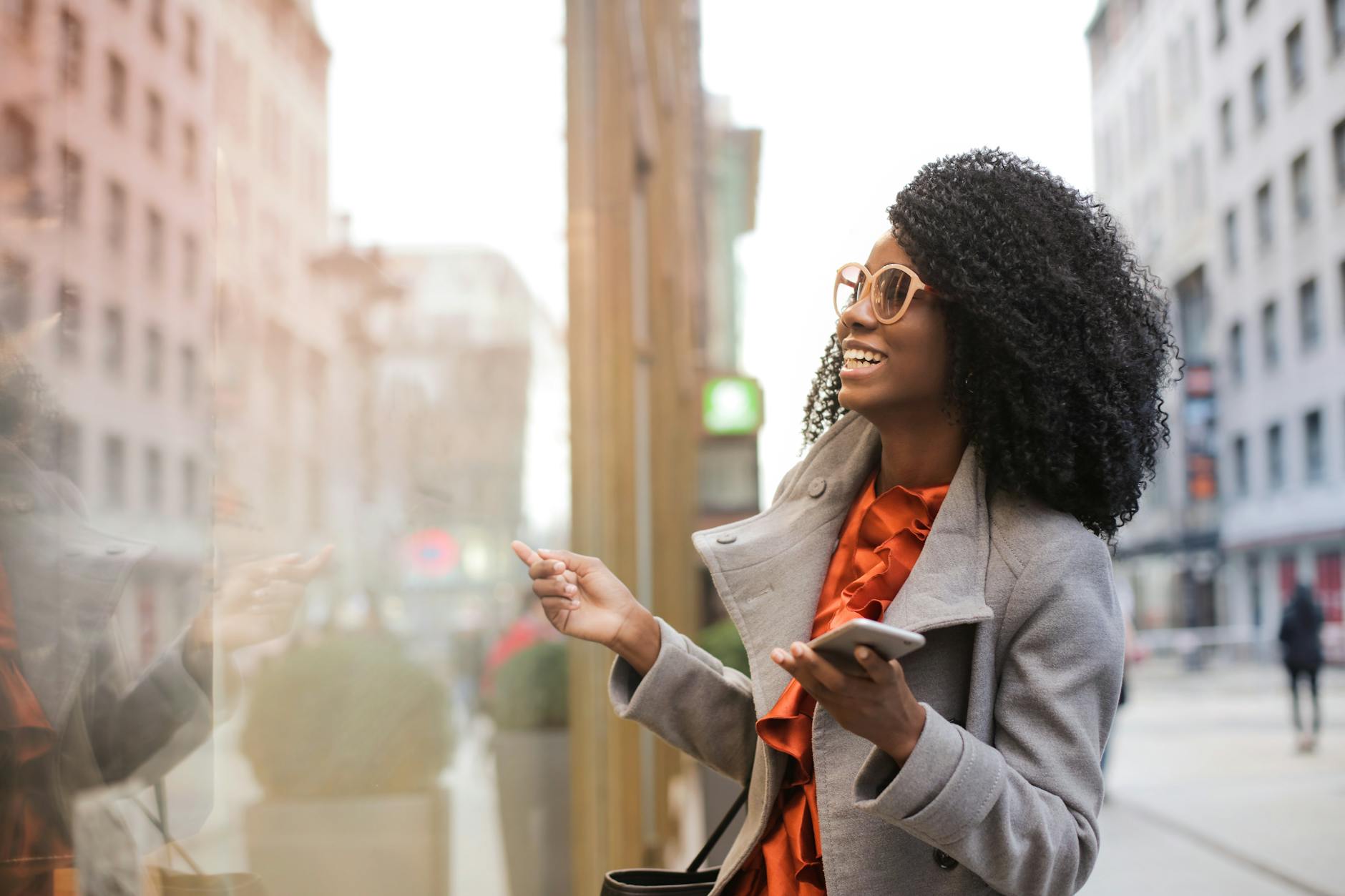 Happy woman laughing on the street