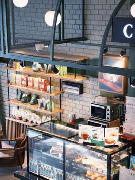 A cozy cafe interior featuring a product display and a warm inviting atmosphere.