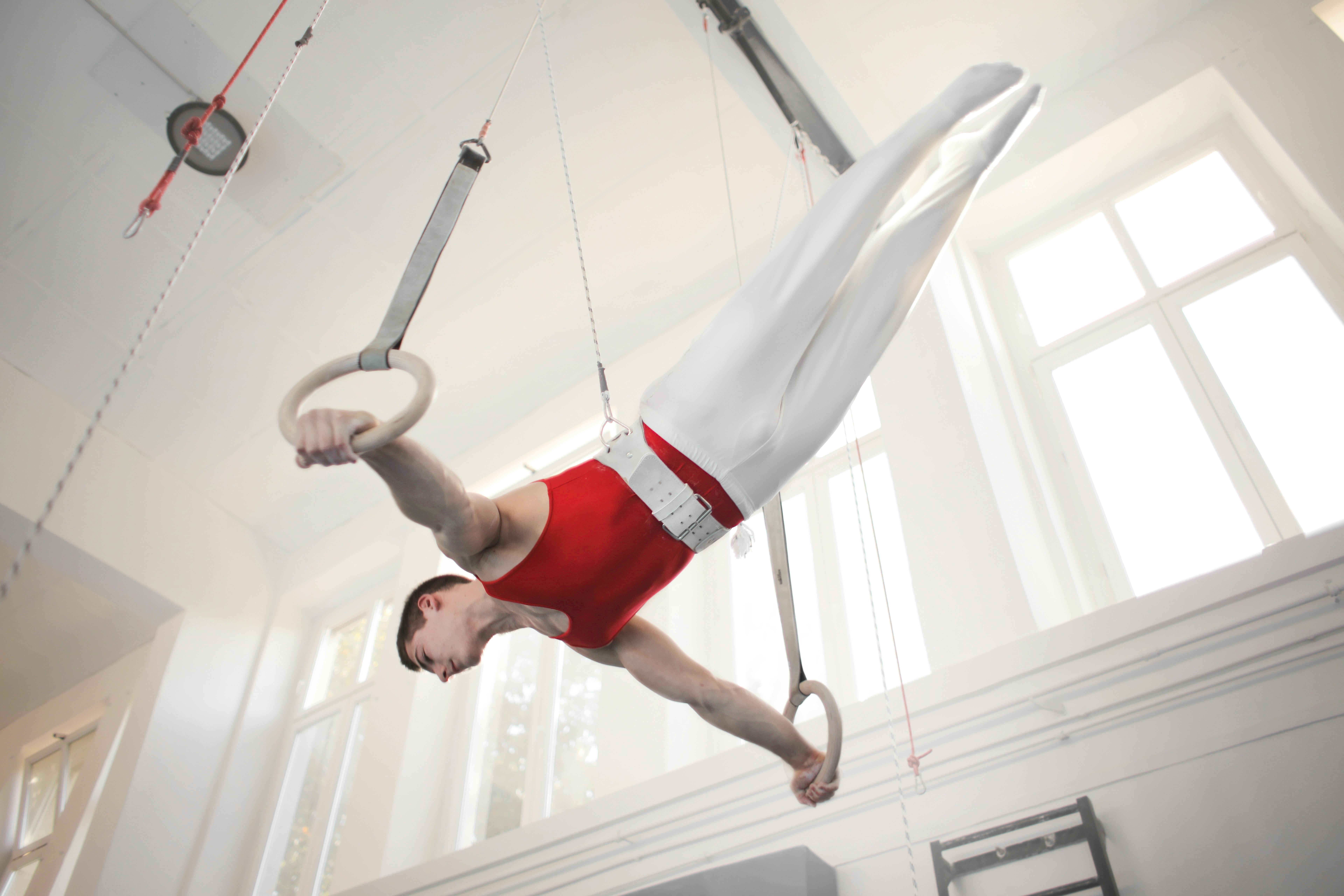 Photo of Male Gymnast Practicing on Gymnastic Rings \u00b7 Free Stock Photo
