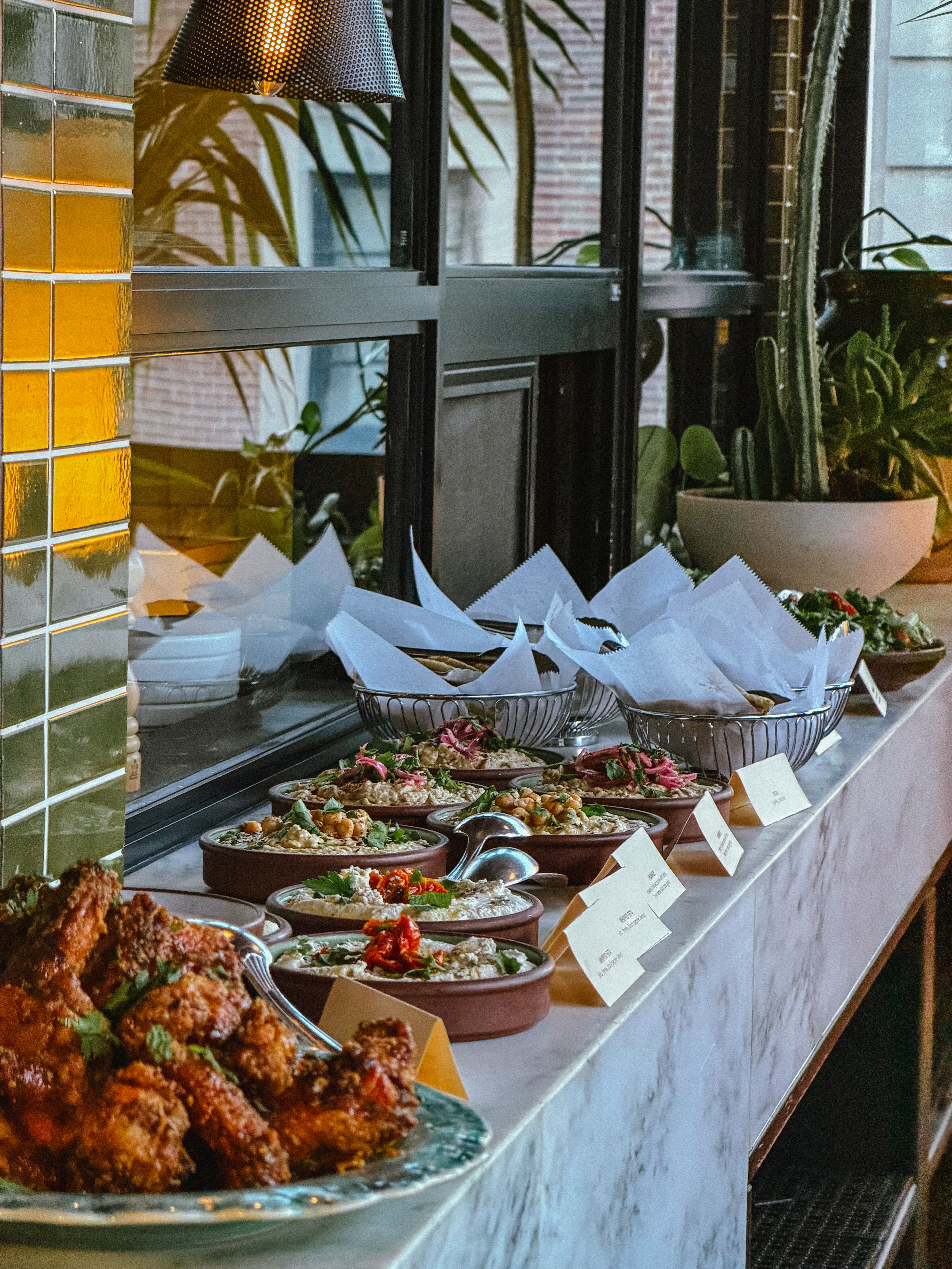 A chef plating dishes beside a prep counter