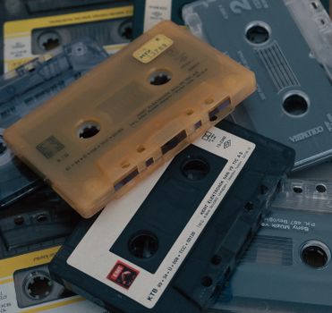 A nostalgic collection of vintage audio cassette tapes, showcasing different colors and designs.