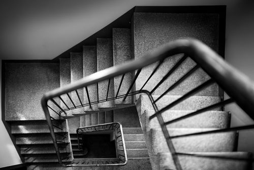 Free Dynamic black and white photo capturing a spiral staircase from above with striking geometric patterns. Stock Photo