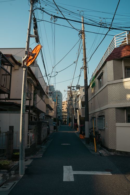 Free Urban street scene in Tokyo, Japan, showcasing traditional architecture and power lines. Stock Photo