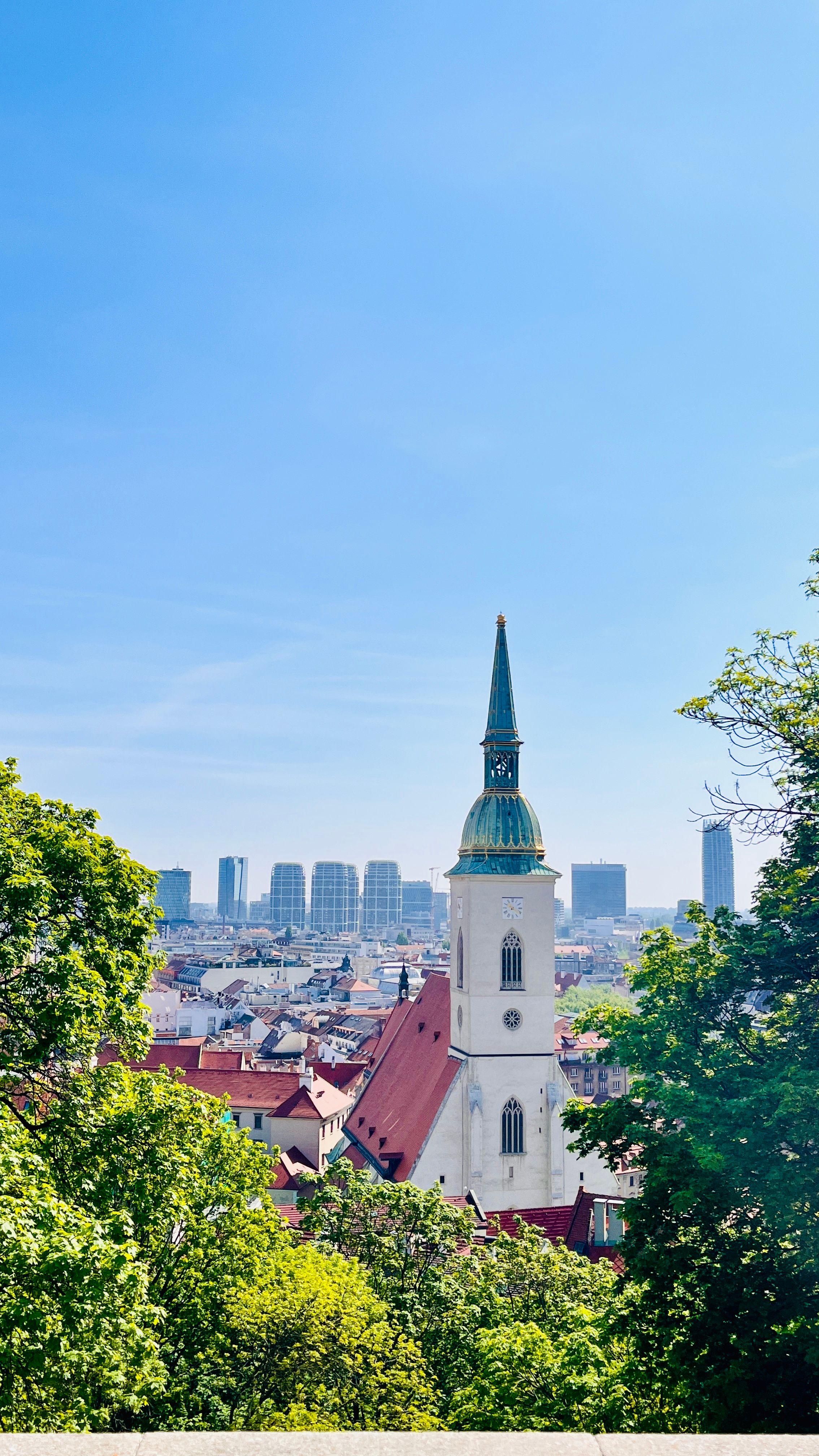 Scenic vista of St. Martin's Cathedral in Bratislava under a clear blue sky.
