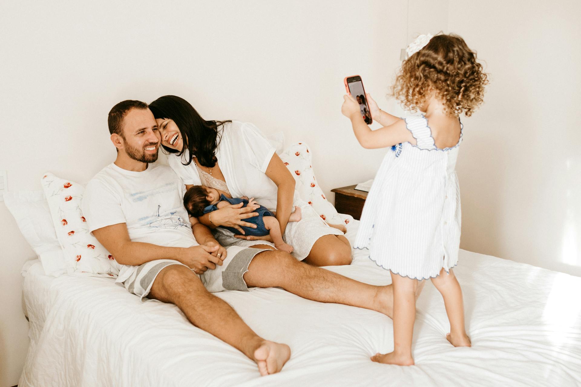 A happy family enjoying quality time, capturing memories with their young children.