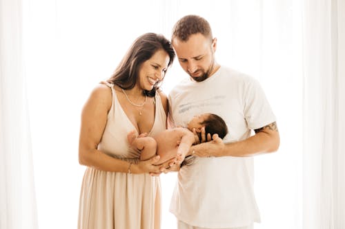 Free Photo of Couple Carrying a Baby Stock Photo