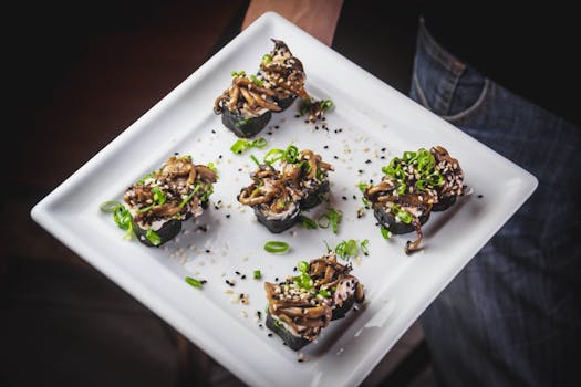 Exquisite sushi rolls presented on a white platter, garnished with sesame and green onions.