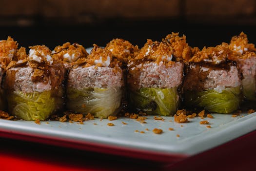 Close-up of gourmet sushi rolls with crunchy toppings, perfect for Asian cuisine lovers.