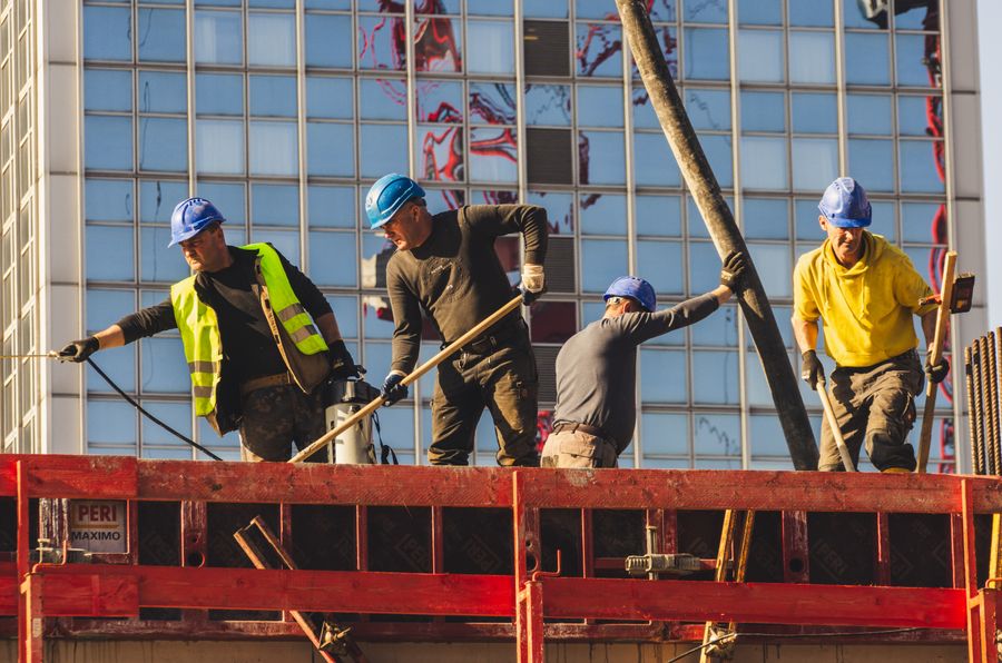 A group of construction workers in safety gear at a building site