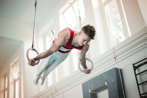 Free  Photo of Male Gymnast Practicing on Gymnastic Rings Stock Photo
