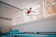 Young professional gymnast jumping on trampoline