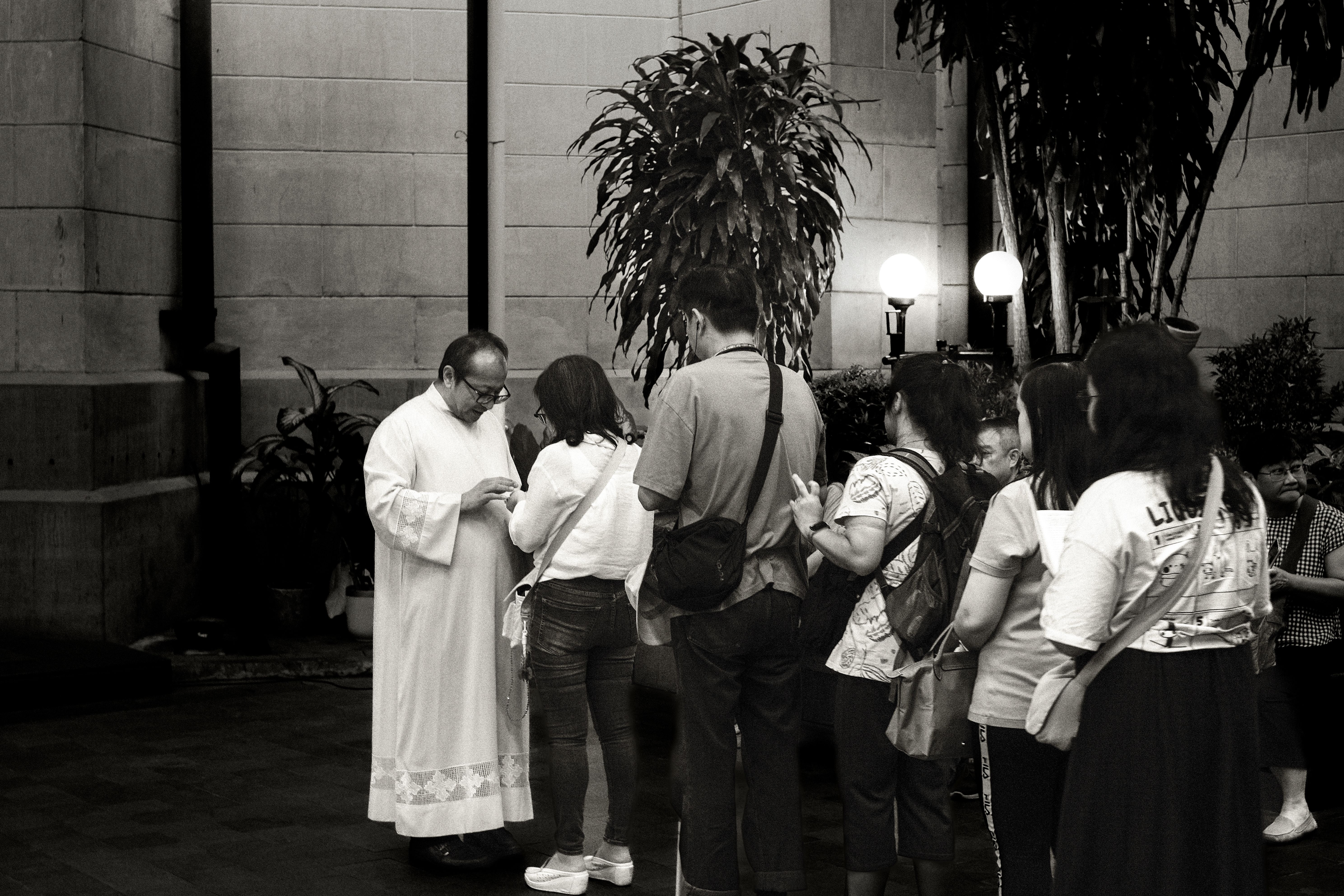 A group of people chatting happily outside a modern church building after service, golden hour lighting