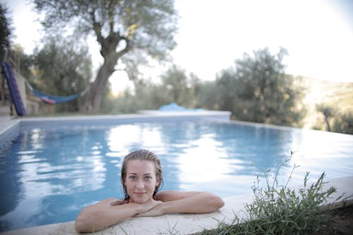 Woman Leaning On Poolside