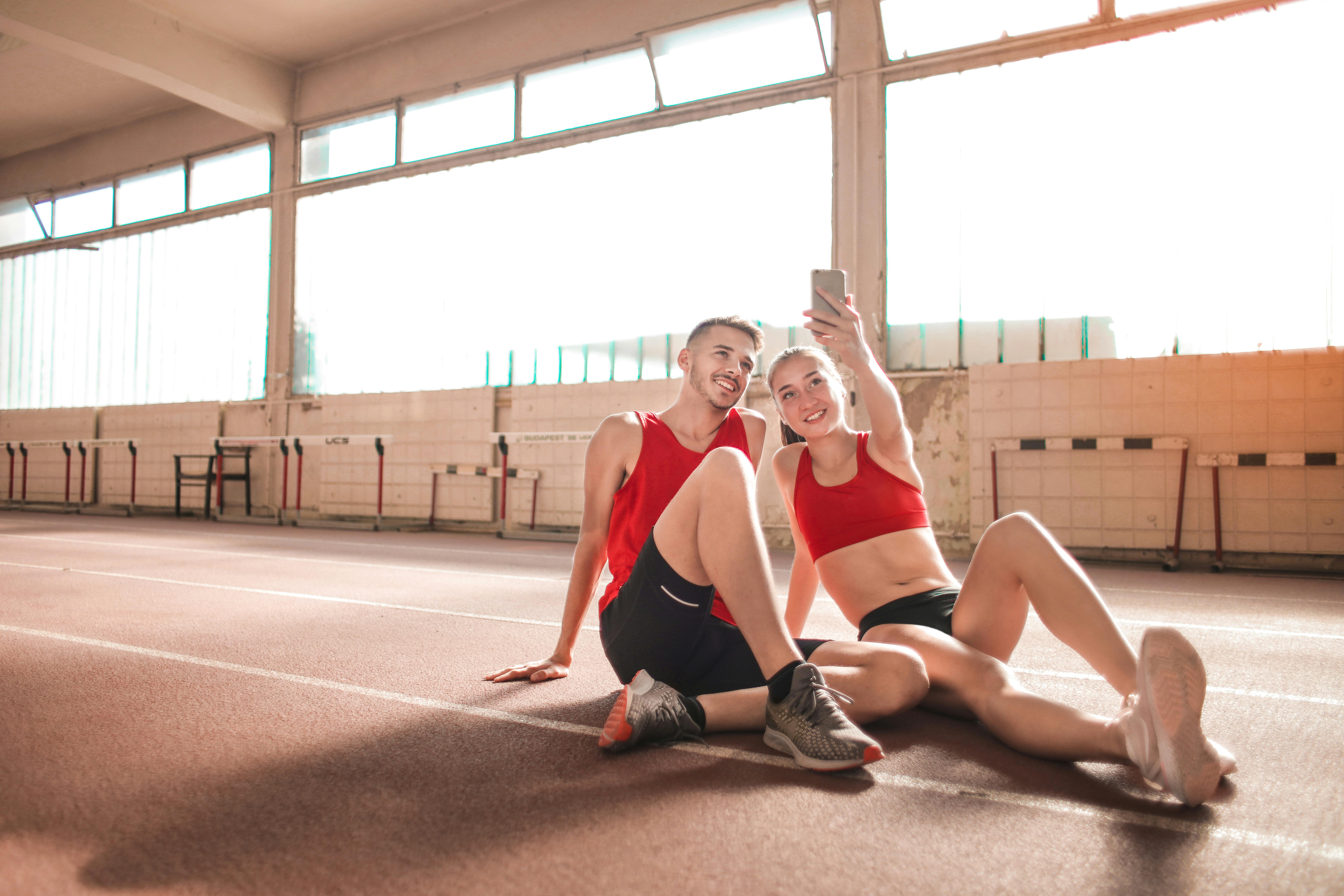 sporty couple taking selfie on gym