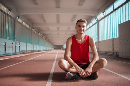 Free Athlete Man In Red Tank Top Sitting On Floor Stock Photo