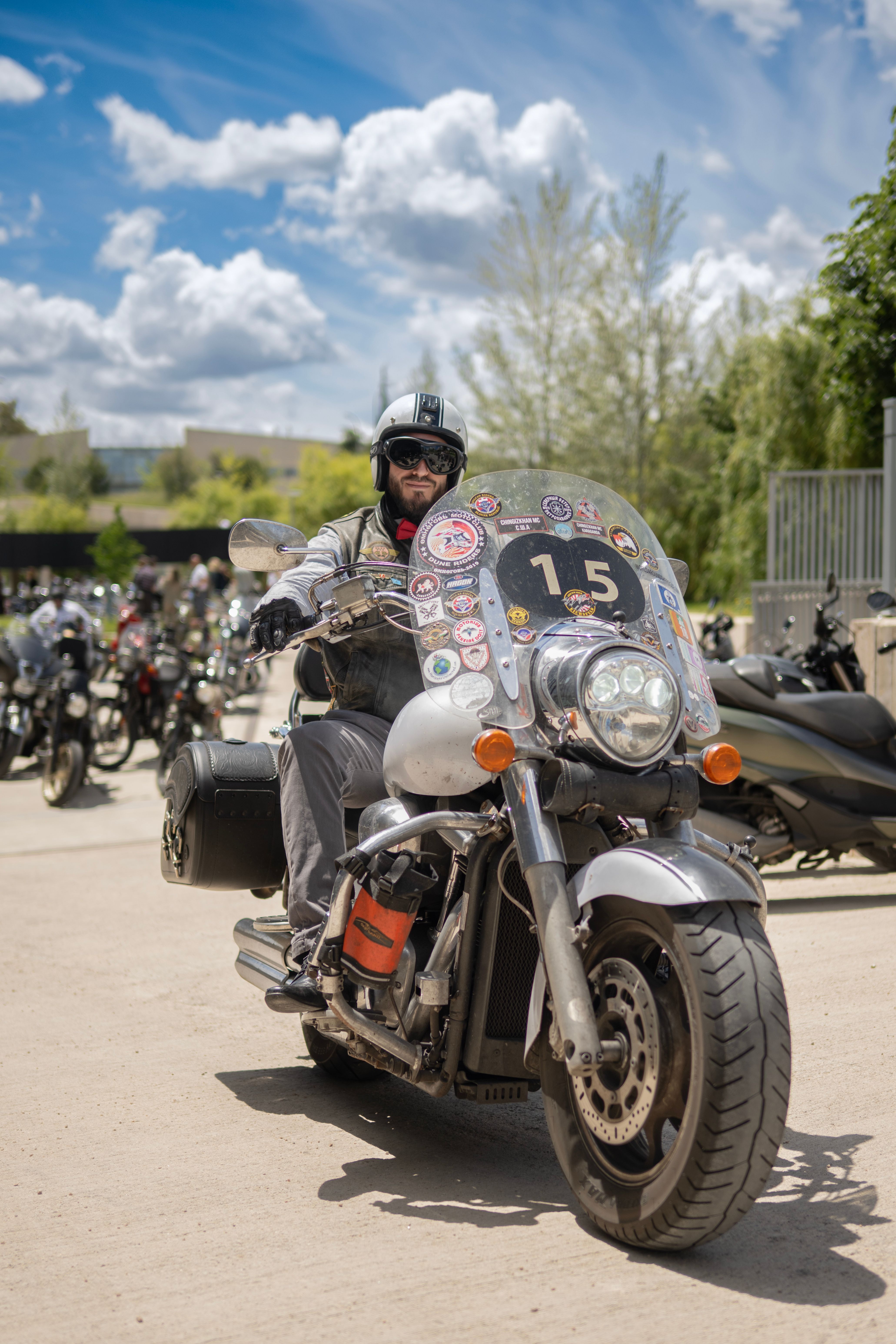 Motorcyclist on Customized Bike in Outdoor Gathering · Free Stock Photo