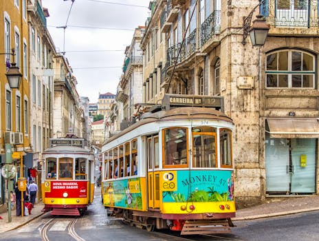 Colorful trams on a vibrant street in Lisbon, showcasing historic architecture and urban life.