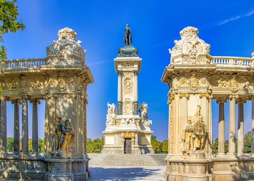 White and Black  Concrete Statues Under Blue Sky