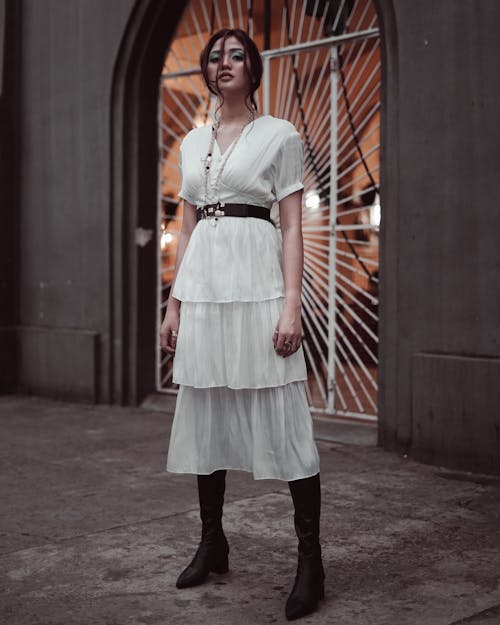 Woman in White Dress Standing Near Wall