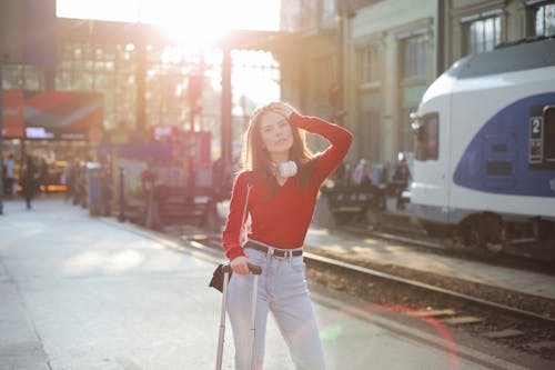 Serious woman posing at railroad station