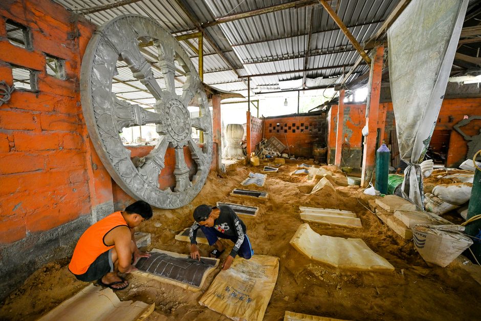 Skilled artisans working in a Magelang workshop creating intricate sculptures.