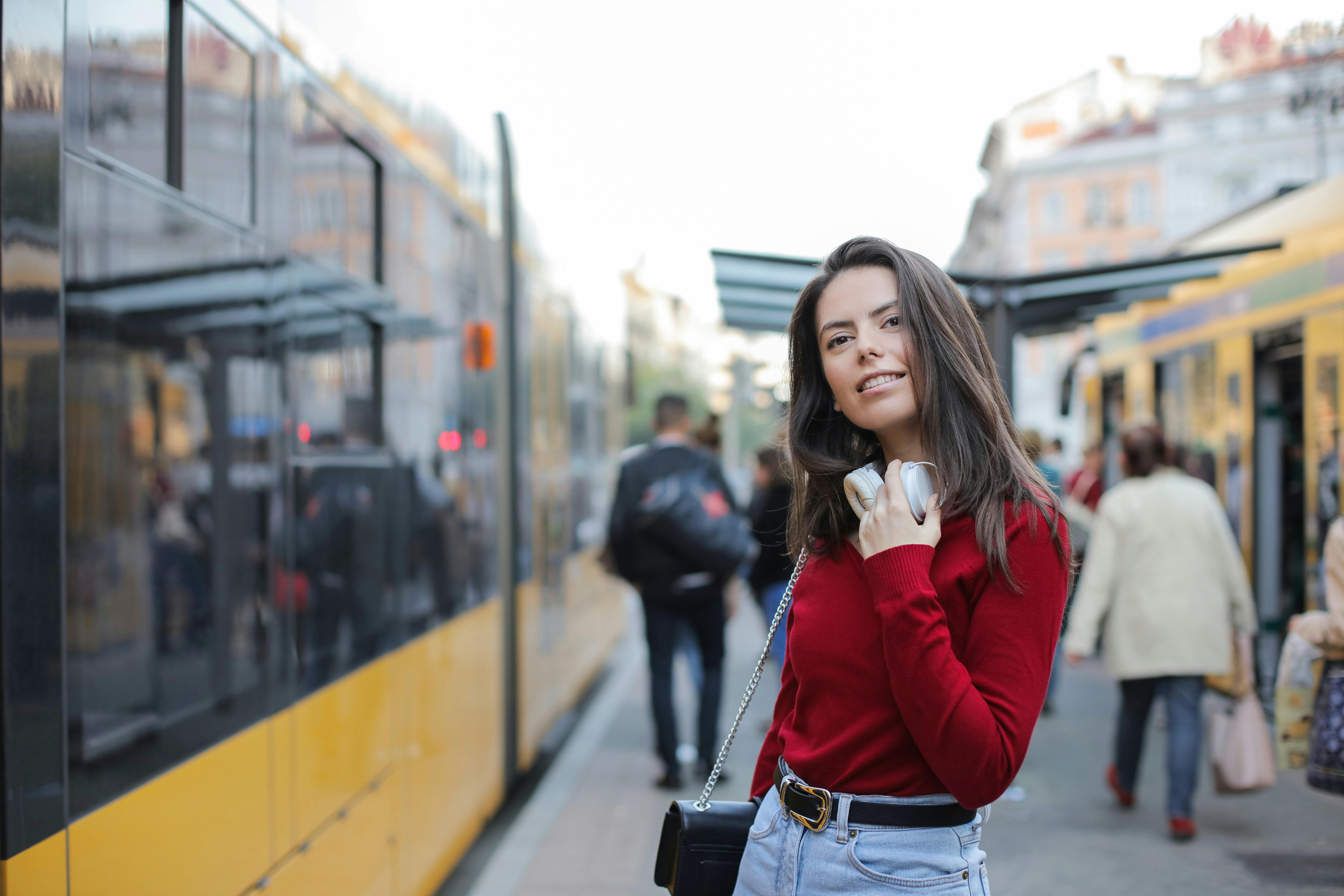 trendy woman standing on train platform