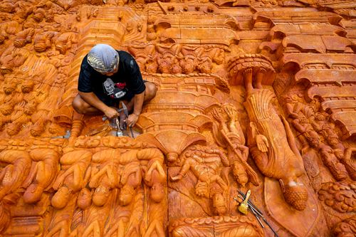 Free An artisan sculpts intricate religious motifs into stone relief in Magelang, Central Java, capturing traditional craftsmanship. Stock Photo