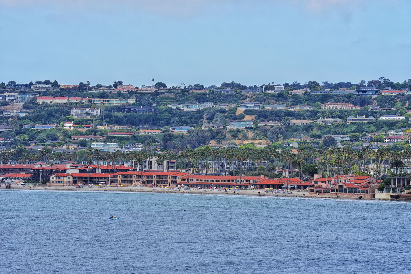 Coastline of La Jolla with hillside homes and calm Pacific water