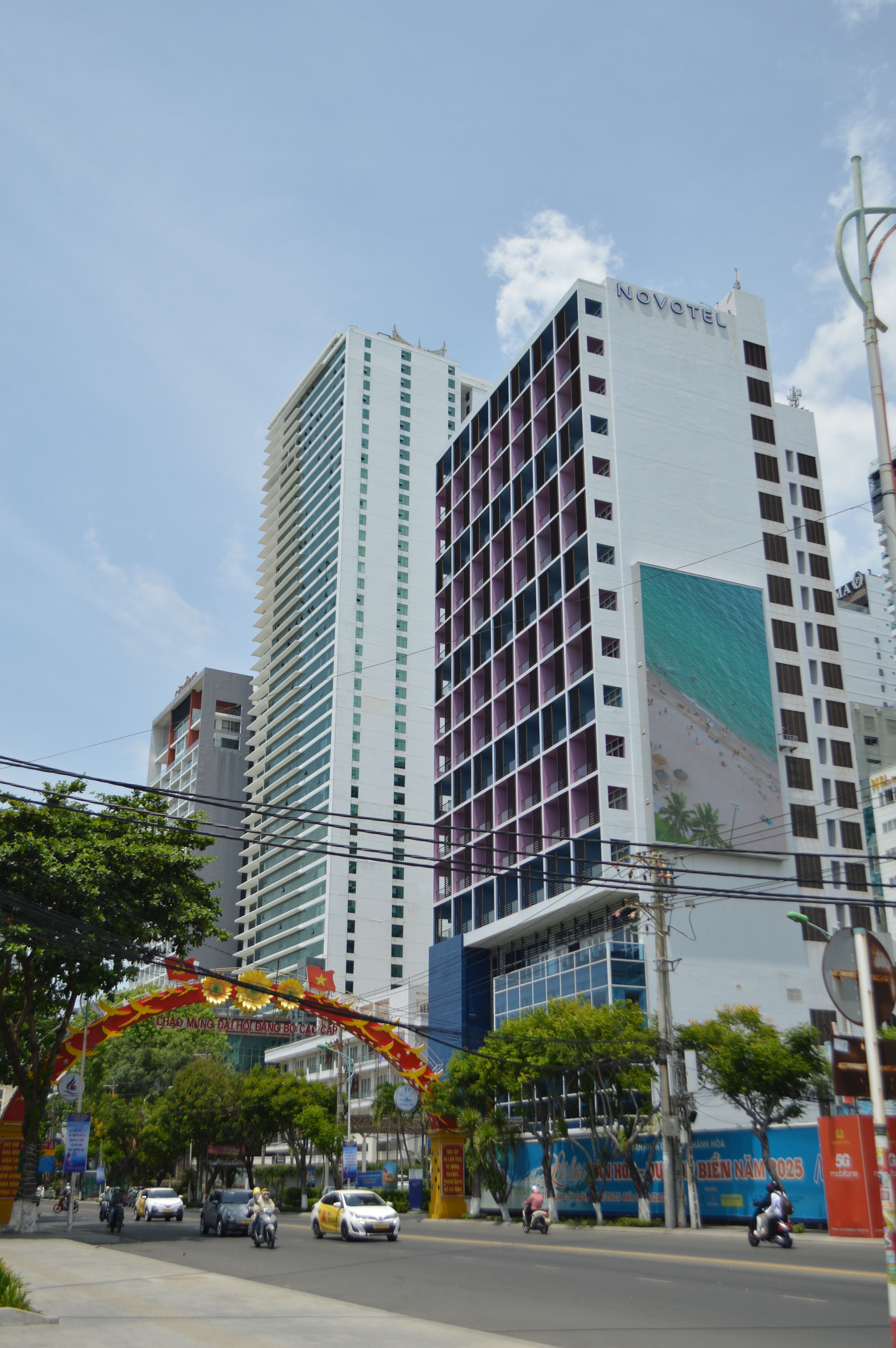 Urban street view showcasing modern skyscrapers and bustling street on a clear day.