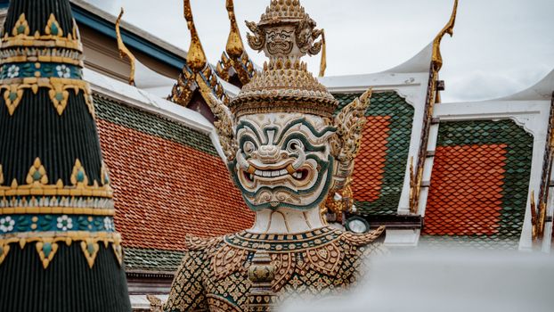 Close-up of a traditional Thai Yaksha statue at Wat Phra Kaew in Bangkok, Thailand.
