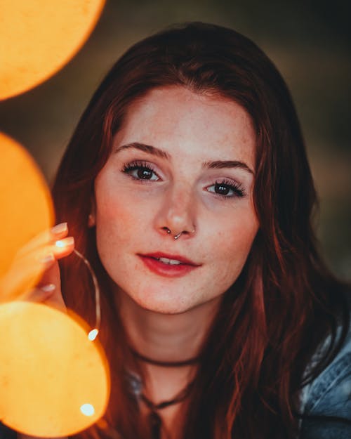 Portrait Photo of Woman Holding Yellow String Lights
