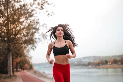 Free Woman in Black Sports Bra Running  Stock Photo