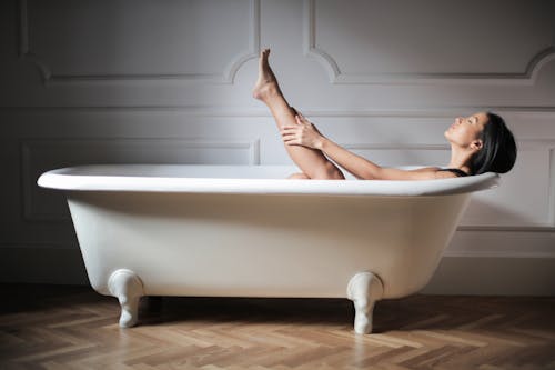 Free Woman Relaxing in Bathtub Stock Photo