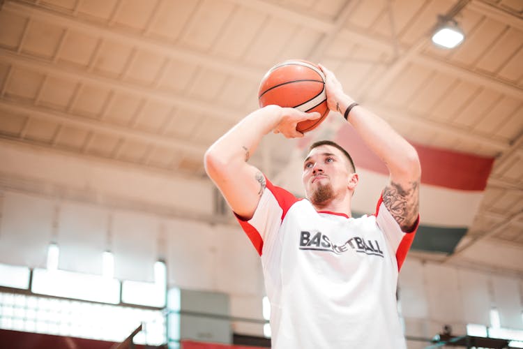 Focused Man Playing Basketball In Basket Hall