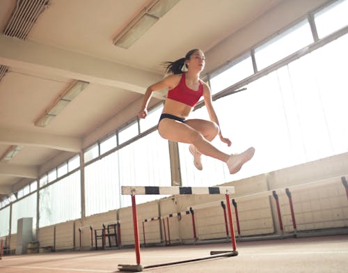 Free Photo of a Woman Jumped on Obstacle Stock Photo