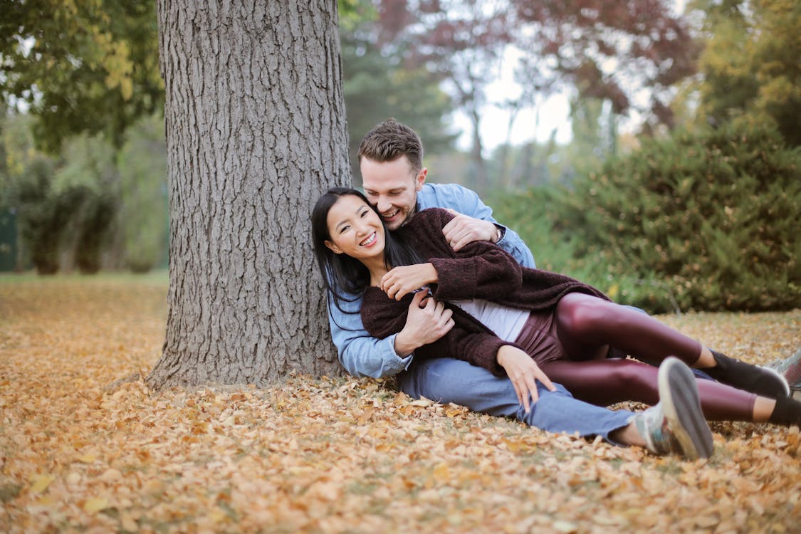 Free Couple Reclining Under The Tree Stock Photo