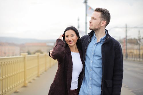 Free Couple Sanding On Sidewalk Stock Photo