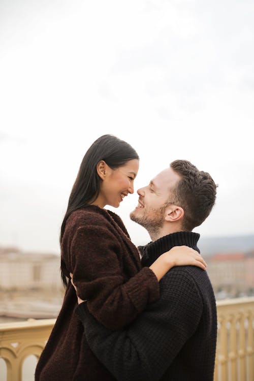 Selective Focus Photo of Man Lifting up His Woman