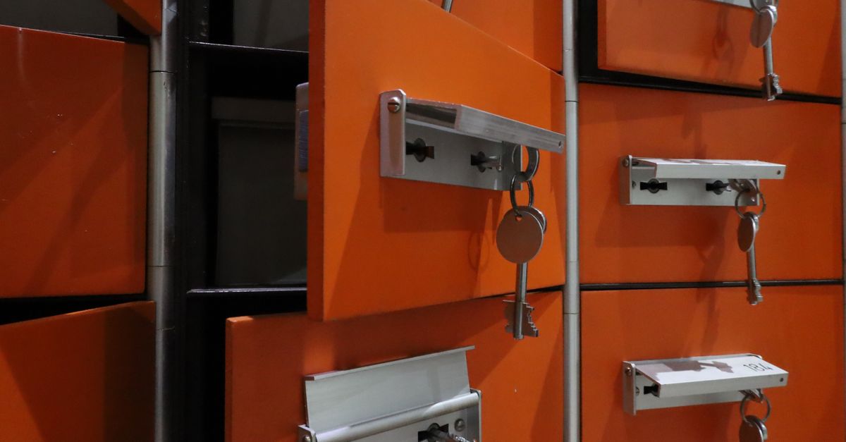 A person holding a glowing key in front of a digital vault with multiple layers of security