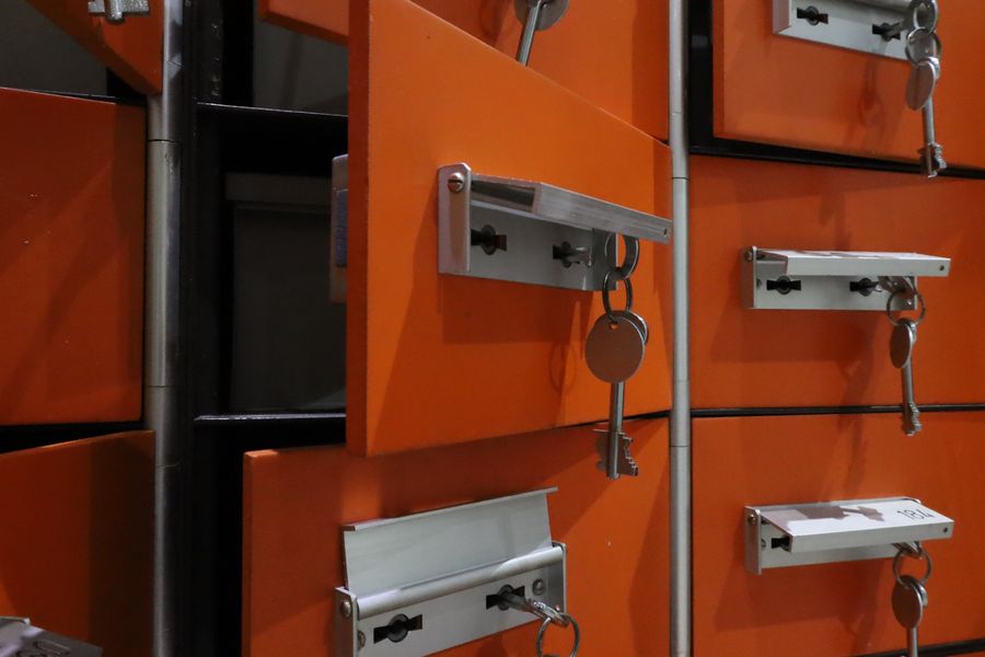 Orange lockers with metal keys highlighted in an indoor setting.